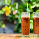 Two iced coffees on a table outdoors